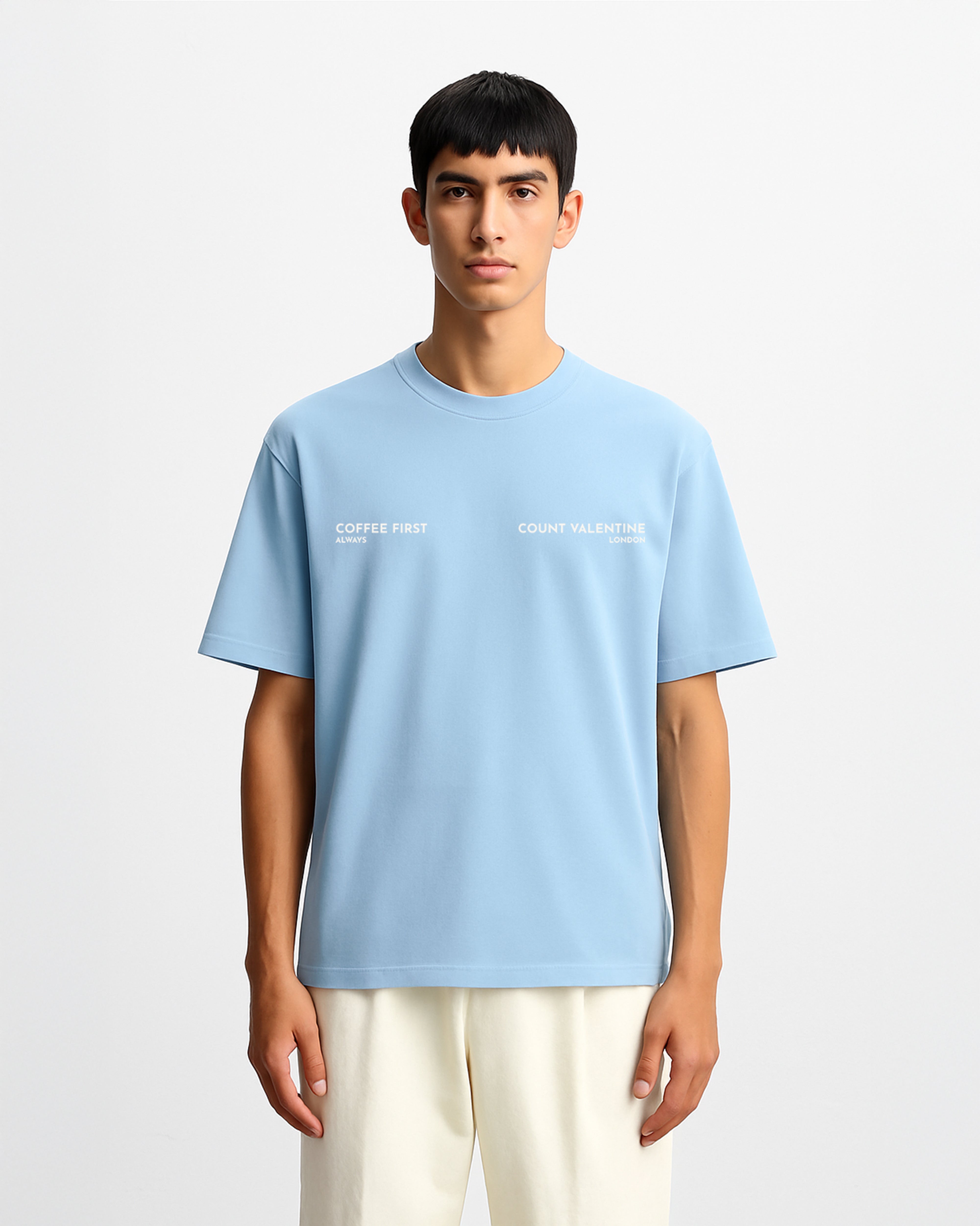 Person wearing a light blue t-shirt with text on a white background