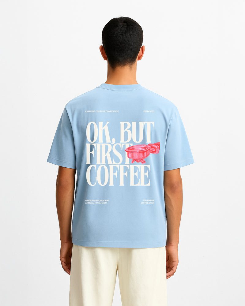 Person wearing a light blue t-shirt with text and graphic on the back.