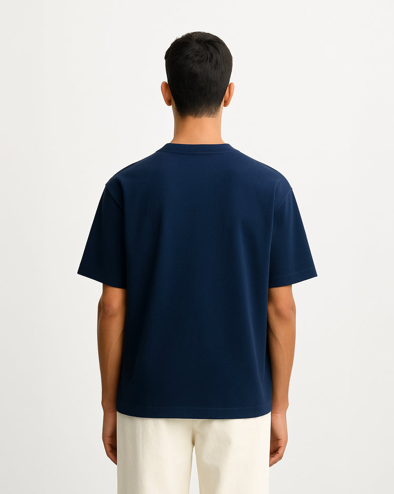 Person wearing a navy blue t-shirt against a plain background