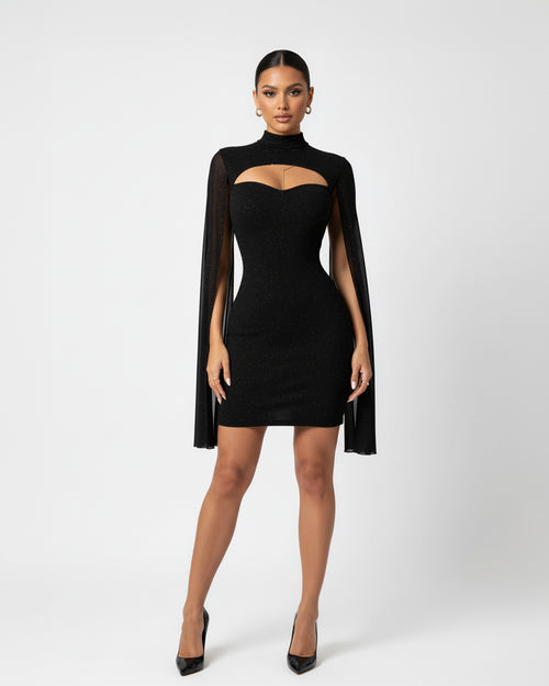 Woman wearing a black dress with cape on a white background