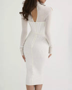 White long-sleeve dress with cut-out back on a white background