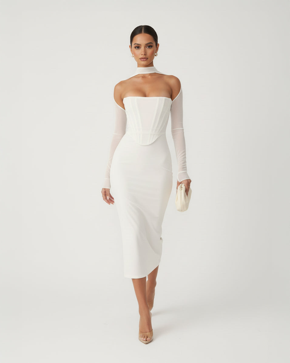 Woman wearing a white strapless dress with long sleeves on a plain background