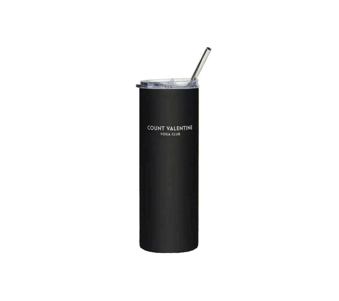 Black tumbler with a straw on a white background