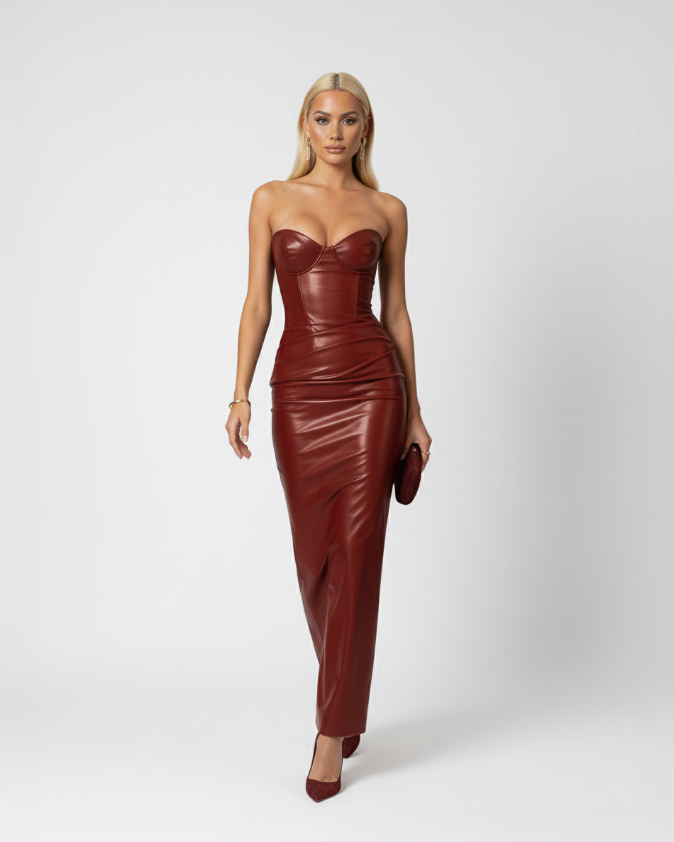 Woman wearing a strapless brown leather dress on a white background